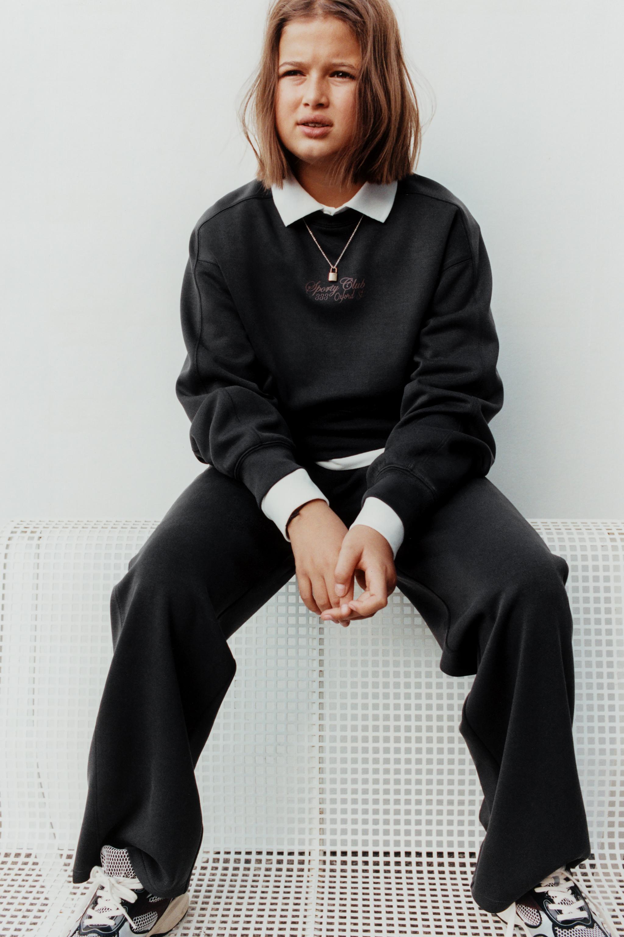 RAISED TEXT SWEATSHIRT